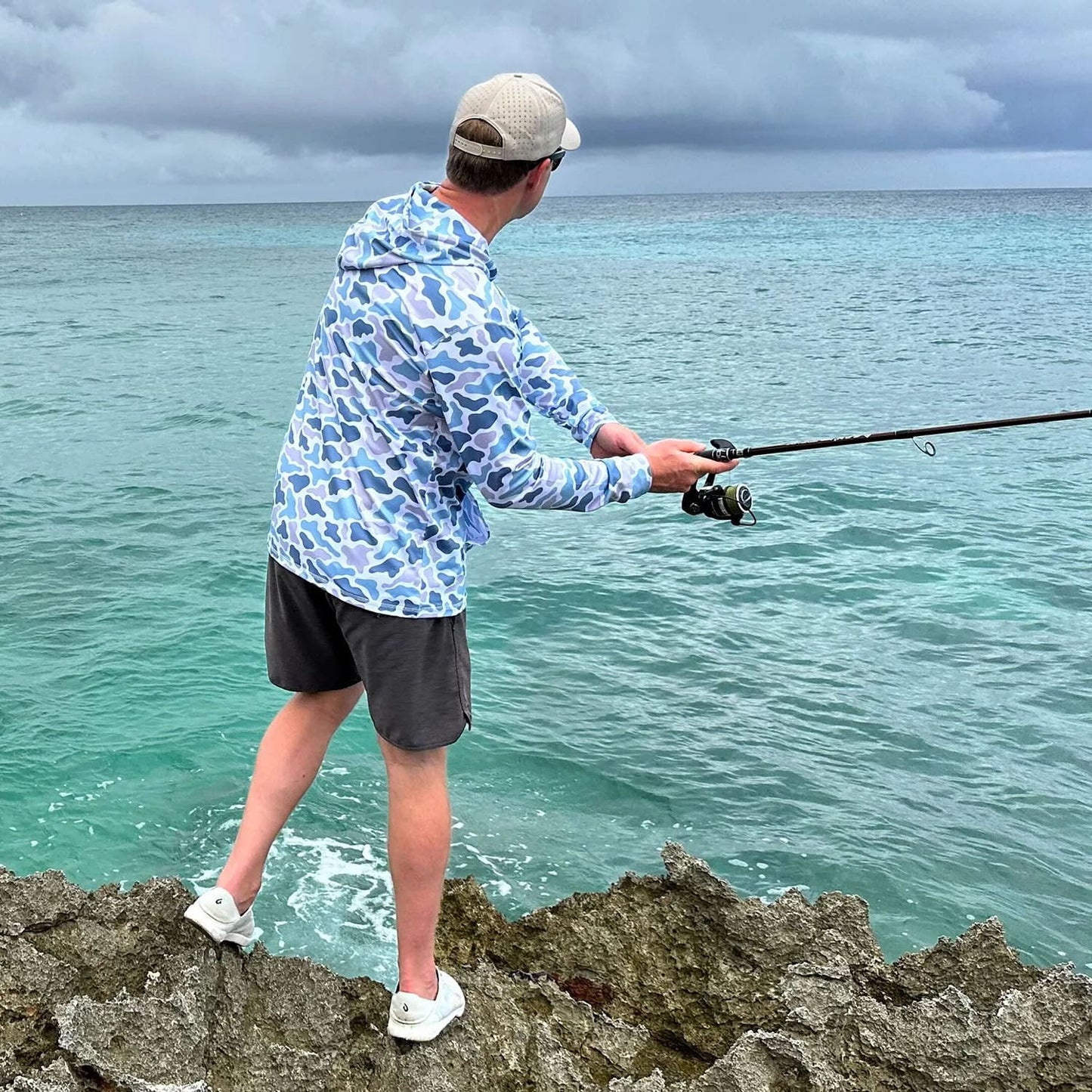 Man fishing in Sint Maarten wearing Six Knots Coastal Camo Performance Hoodie – Chesapeake – Lightweight Fishing Apparel