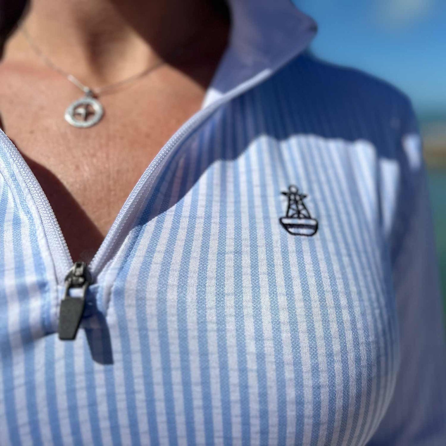 Close-up of blue seersucker stripe detail on the Six Knots Seafarer Women's Performance Quarter Zip — lightweight, moisture-wicking pullover designed for comfort and sun protection during fishing, sailing, and coastal outings