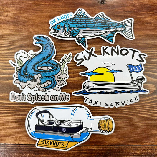 Overhead view of four unique Six Knots vinyl stickers with coastal and nautical-themed designs — durable, waterproof decals perfect for decorating coolers, tumblers, tackle boxes, water bottles, and other boating or outdoor gear