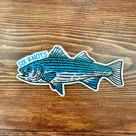 Overhead view of Six Knots "Striped Bass" vinyl sticker featuring a blue striped bass and Six Knots text — durable, waterproof decal for coolers, boats, and outdoor gear