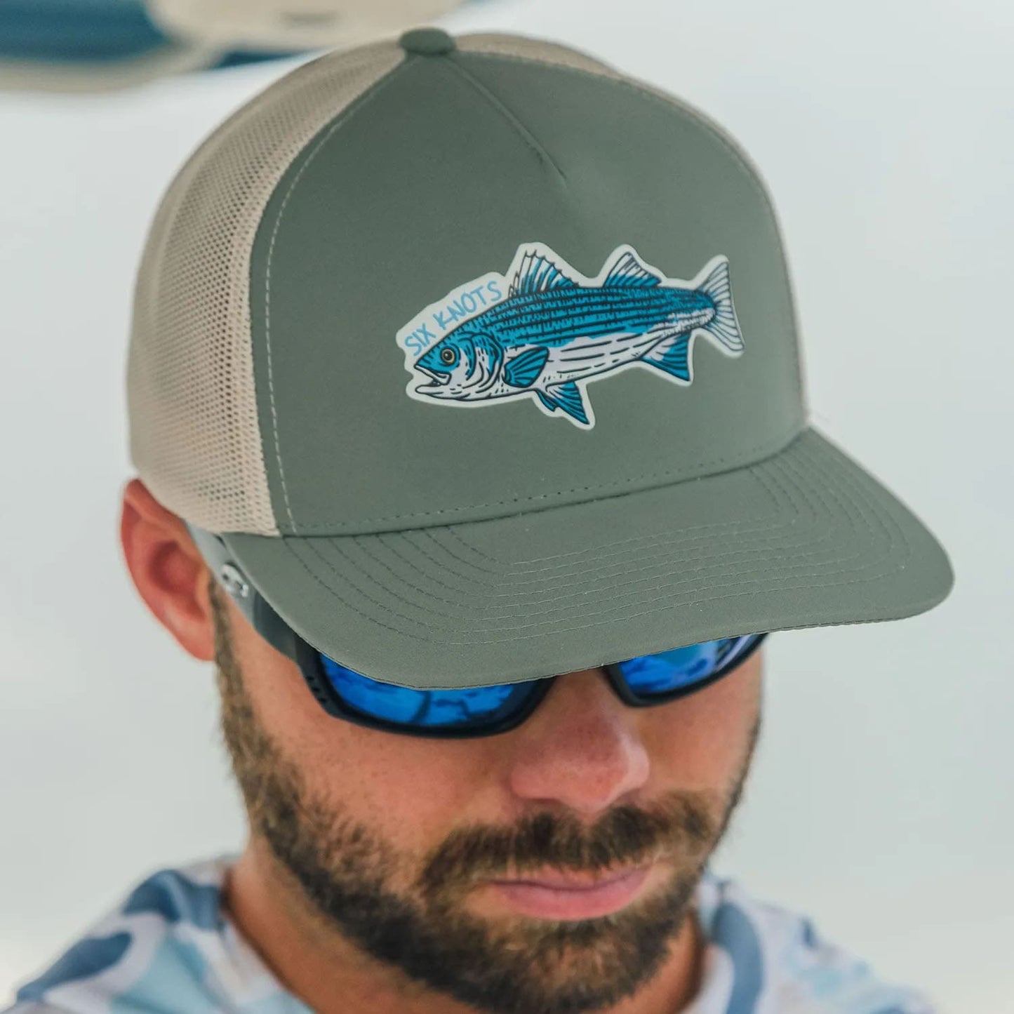 Close-up of man in sunglasses wearing a Six Knots Trophy Season Snapback Hat — water-resistant, breathable boating and fishing hat