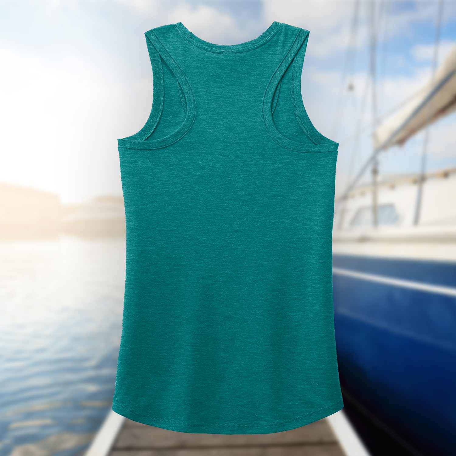 Back view of the teal Six Knots Tropical Storm Women's Tank Top set against a blurred marina background. This lightweight, ultra-soft women's tank is crafted from a breathable cotton-polyester blend for all-day comfort. Ideal for beach outings, coastal vacations, boating adventures, summer festivals, and relaxed waterfront style, it's the perfect warm-weather essential for active coastal living.