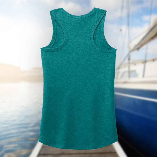 Back view of the teal Six Knots Tropical Storm Women's Tank Top set against a blurred marina background. This lightweight, ultra-soft women's tank is crafted from a breathable cotton-polyester blend for all-day comfort. Ideal for beach outings, coastal vacations, boating adventures, summer festivals, and relaxed waterfront style, it's the perfect warm-weather essential for active coastal living.
