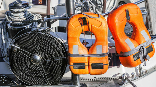 Life jackets next to rope on a boat